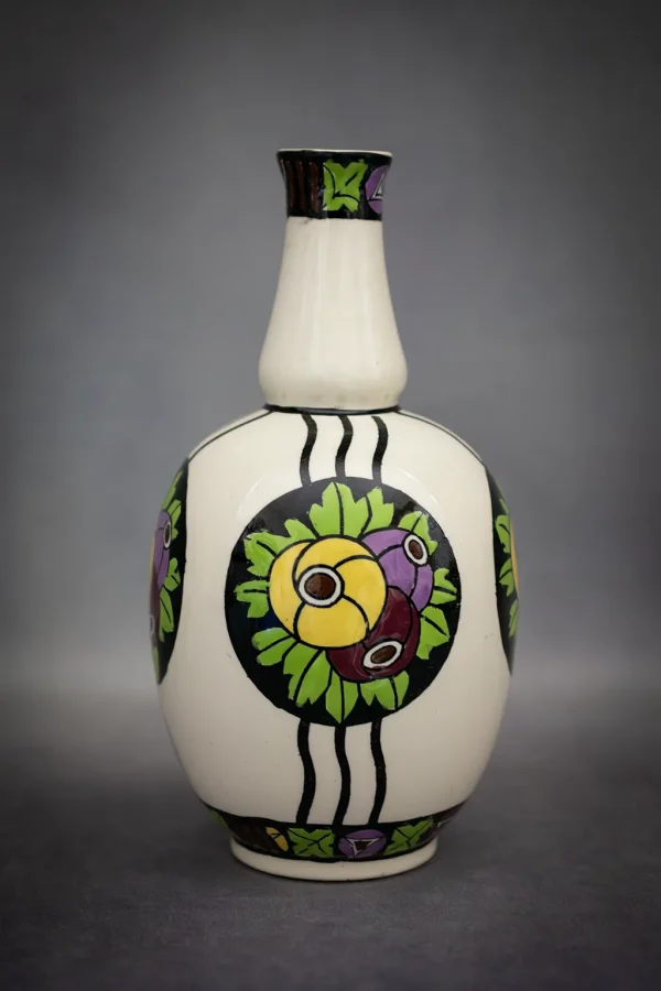 Vase Catteau pour Boch Keramis en faïence fine avec décor de fleurs stylisées dans des médaillons noirs. Vue de face.